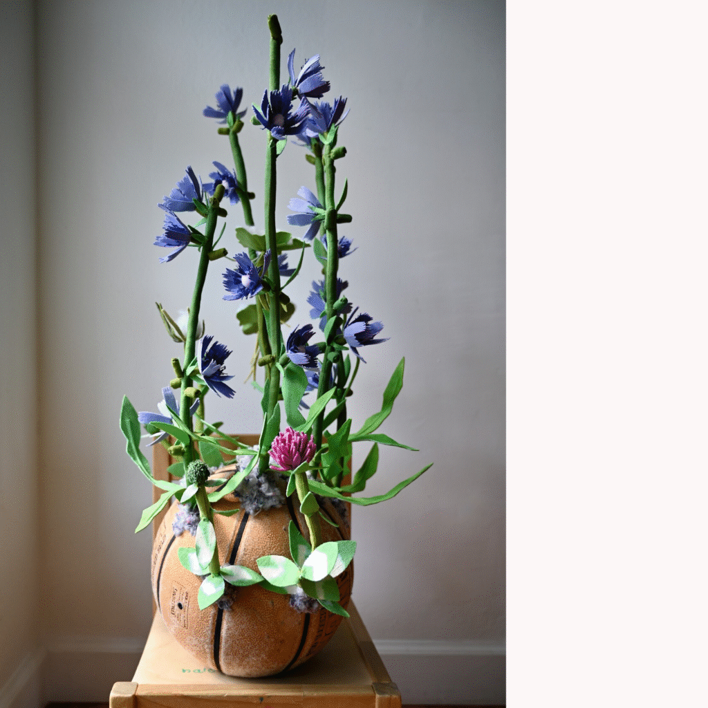 Alissa Alfonso, Chicory, Red Clover, Wild Carrot, 2025, hand—dyed textile waste, reused fiber—fill, embroidery floss, thread, textile stabilizer; base: street recovered basketball, shredded textile shoddy, 28 x 17 x 17 in.